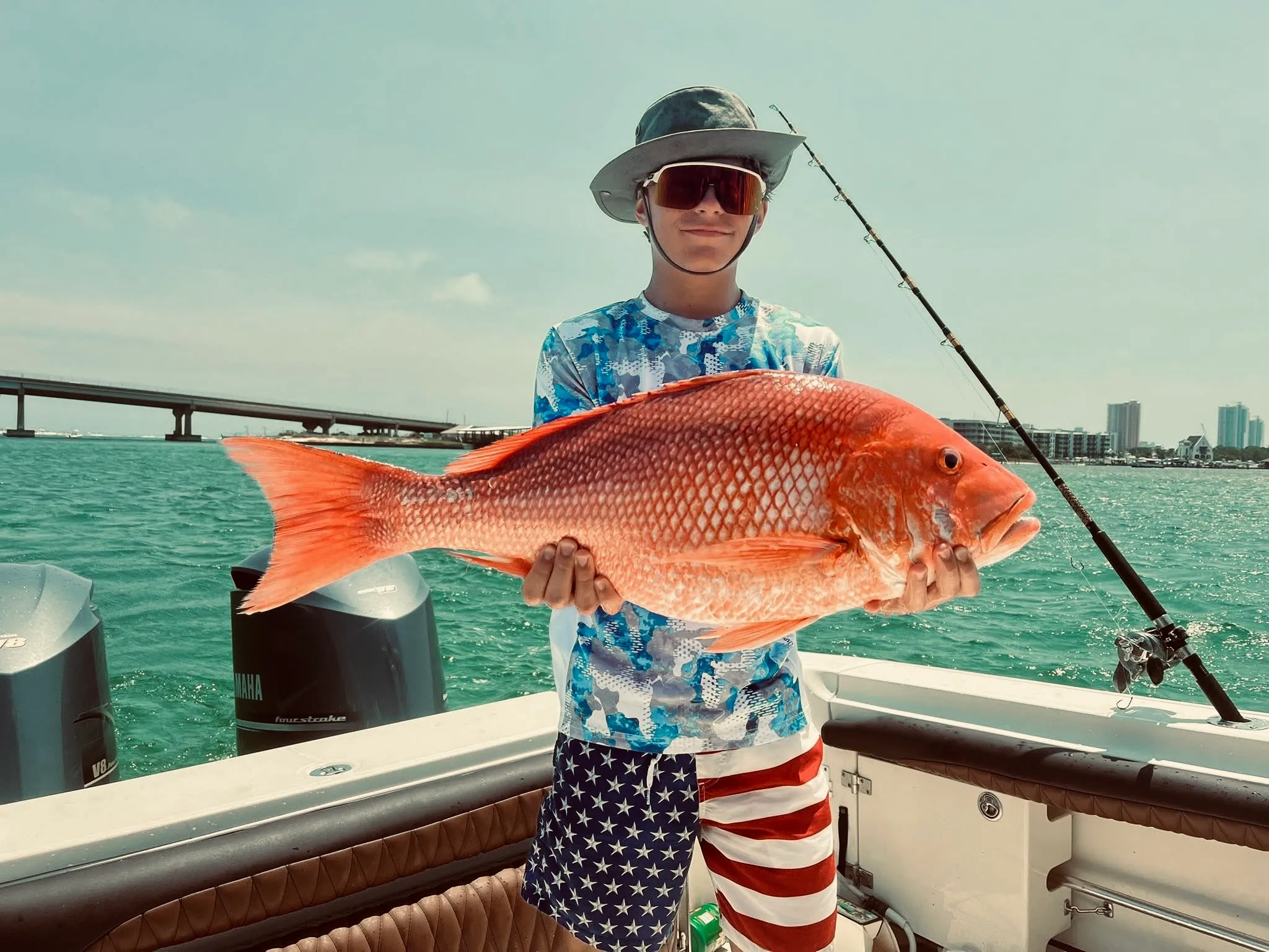 Young angler holding large red snapper on Deep South Charters Orange Beach Alabama