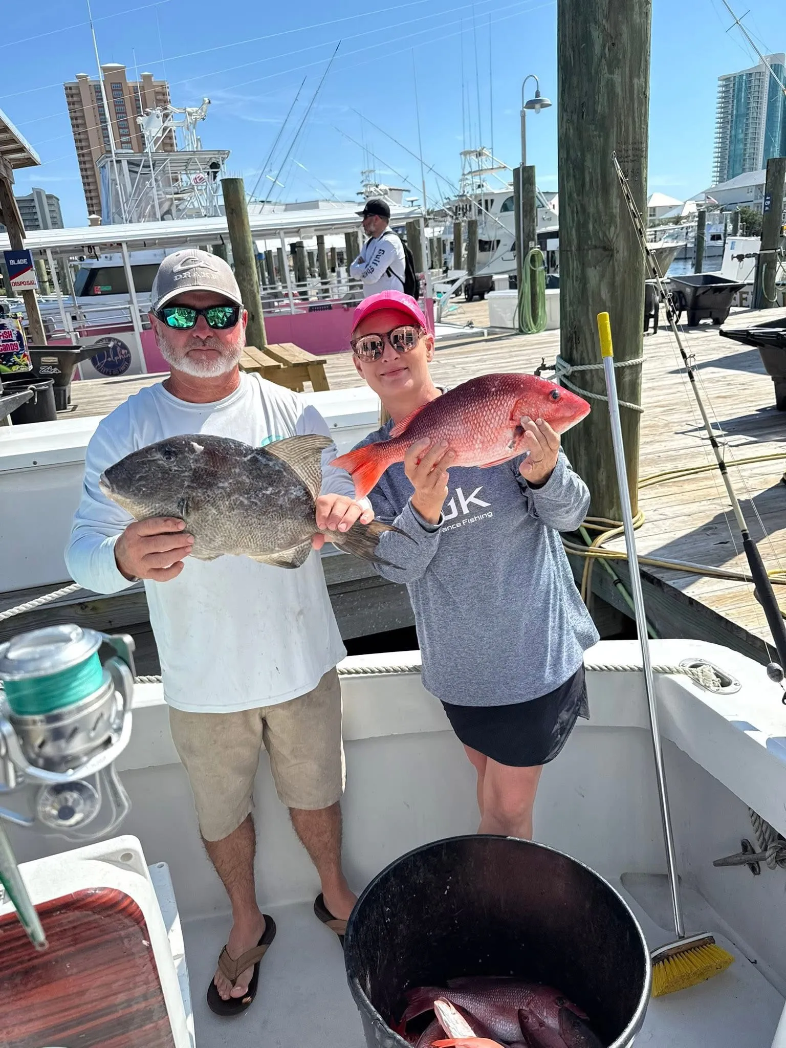 Anglers displaying triggerfish and red snapper catch Orange Beach Alabama